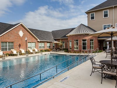 Swimming pool area with lounge chairs and umbrellas