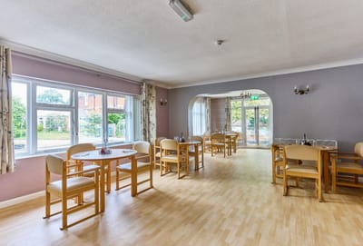 Bright dining area with wooden tables and chairs