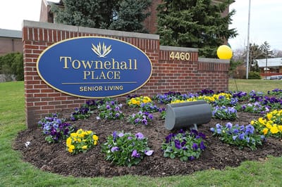 Facility logo in flower bed outside the entrance