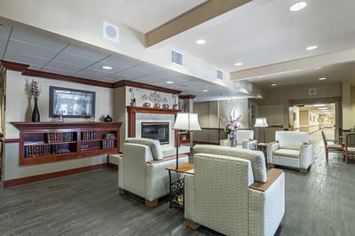 Common area with seating and decor in a senior living facility
