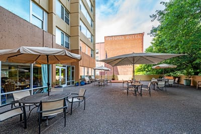 Outdoor patio area with tables and umbrellas