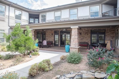 Building entrance with outdoor seating and landscaping