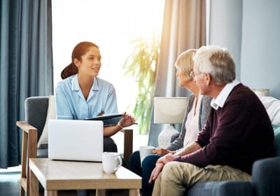 Caregiver engaging with senior residents in a common area