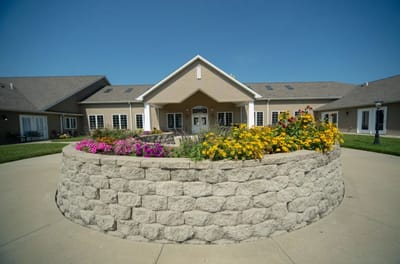 Exterior view of the facility with flowerbeds