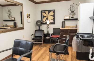 Interior view of a hair salon room with seating