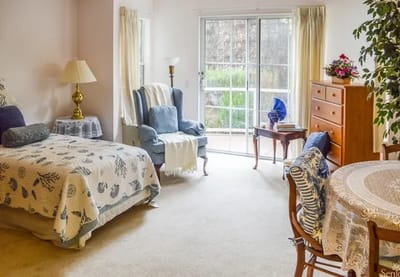Cozy resident room with a bed and seating area