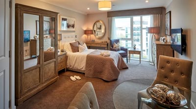 A well-furnished private resident room with natural light