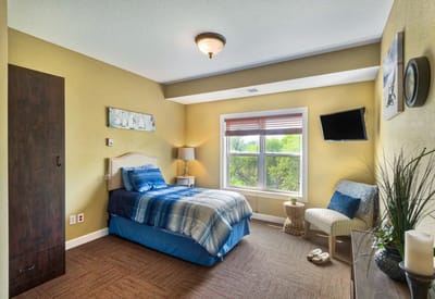 Cozy interior view of a resident's room with a single bed