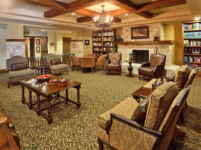 Common area lounge with seating and bookshelves