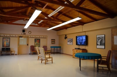 Common area with tables and chairs in a recreation room