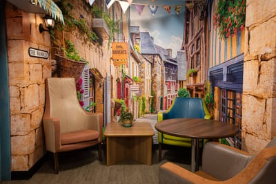 Decorative interior seating area with a mural backdrop