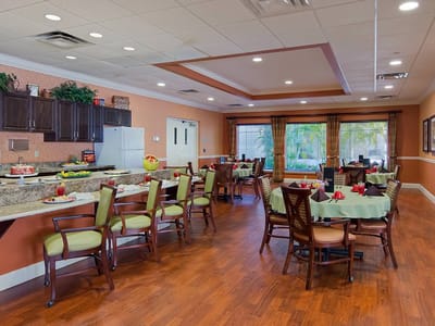 A bright dining area with tables and chairs set up