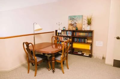 Cozy reading area with a table and bookshelves