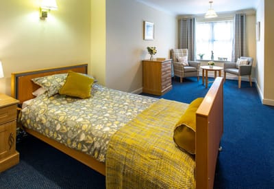 Private resident room with bed and seating area