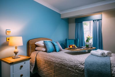 Cozy resident room with blue accents and bright window