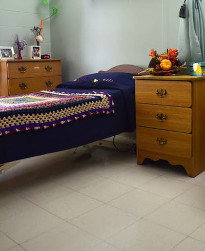 Worland Healthcare & Rehabilitation Center, Nursing Home in Worland, WY — Cozy bedroom setup with a bed and nightstands