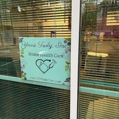 Logo for Yours Truly Home Care displayed on a window