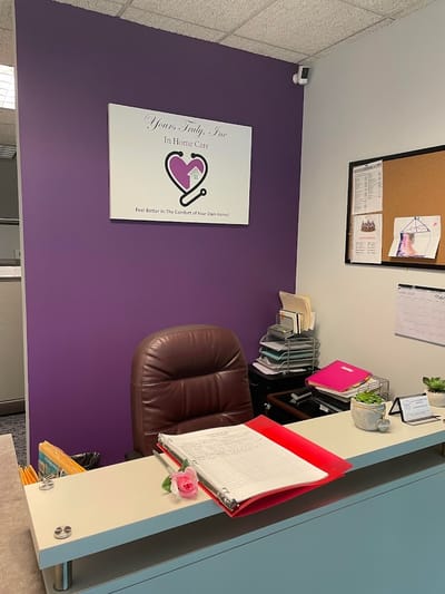 Reception area with facility logo on the wall