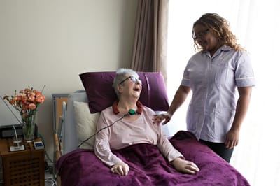 Staff member interacting with a resident in a room