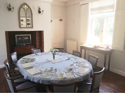 Dining room set up for a meal with a round table