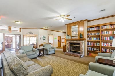 Interior view of a cozy common area with seating and bookshelves
