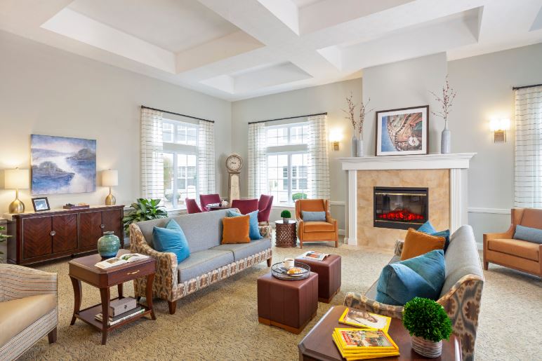 Bright common area with comfortable seating and a fireplace