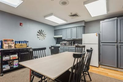 Bright common area with kitchen and dining table