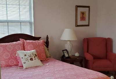 Cozy private room with bed and chair