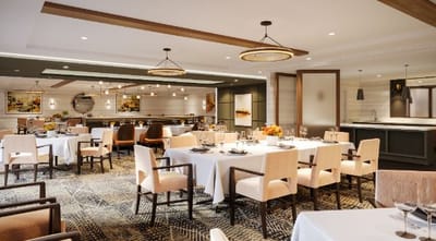 Elegant dining room with tables set for residents