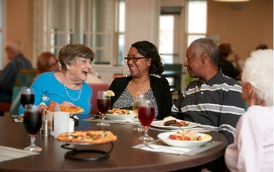 Residents enjoying a meal at a dining table
