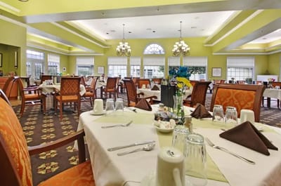 Dining area with tables and chairs set for dining