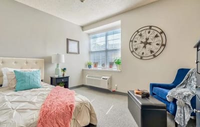 Cozy resident room with bed and seating area