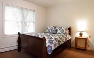 Cozy bedroom with a bed and bedside lamp