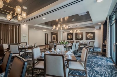 Bright dining room with tables set for meals