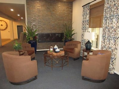 Cozy seating area in a common space with plants