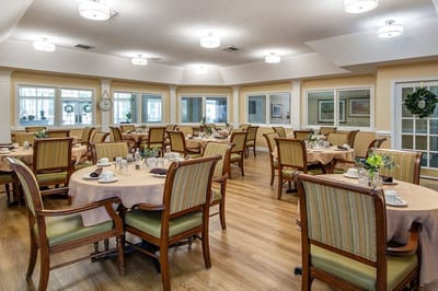 Dining room set for a meal with tables and chairs