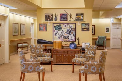 Common area with comfortable seating and decor in a senior facility