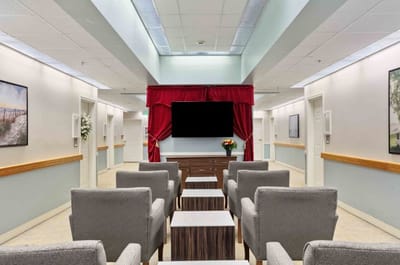 Bright common area with seating and a TV