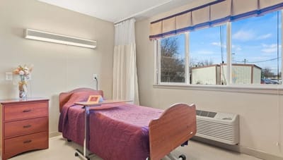 Private resident room with a bed and window