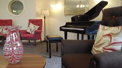 Cozy lounge area with piano and comfortable seating
