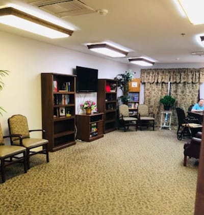 Common area with seating and a TV in the facility