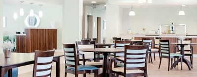 Bright dining area with wooden tables and chairs