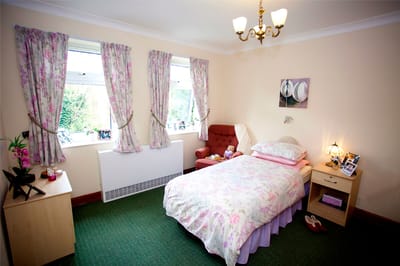 Cozy resident room with floral bedding and decor