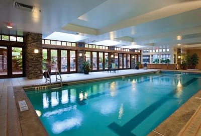 Indoor pool area with natural lighting and plants