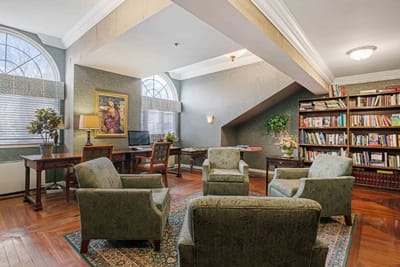 Cozy interior common area with seating and bookshelves