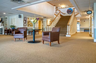 Bright and welcoming common area with seating and staircase