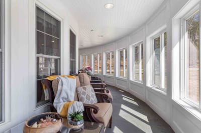 Sunlit lounge area with comfortable seating and large windows