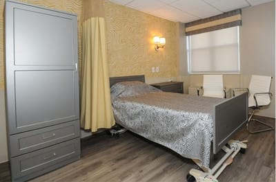 A well-furnished resident room in a senior care facility