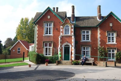 Exterior view of a senior care facility with outdoor seating
