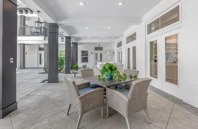Outdoor seating area with plants and tables